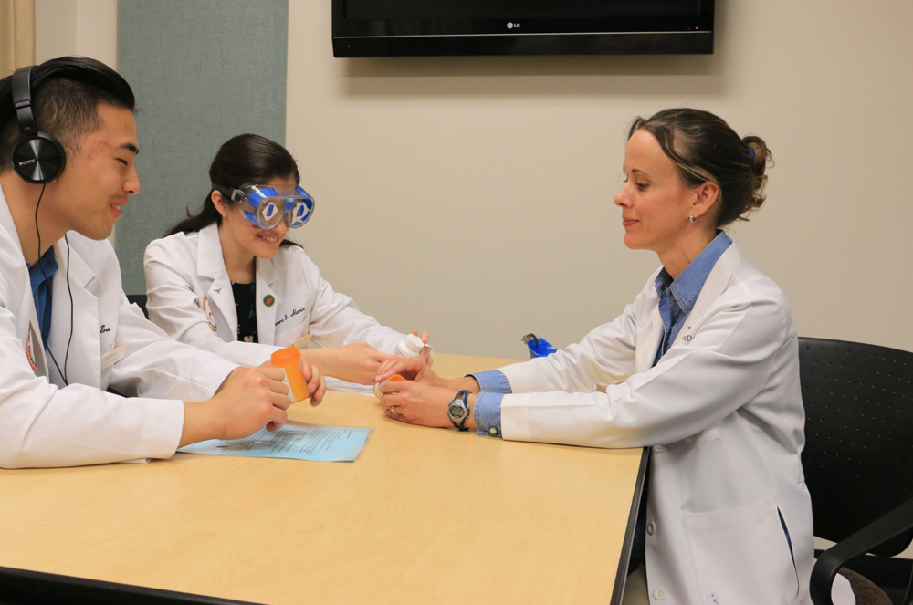 Professor and students practicing building empathy for elderly patients